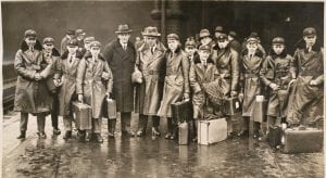 Dean A.V. Baillie, Sydney Nicholson (organist) and the choir boys of Westminster Abbey on a train platform in Canada, February 1927.