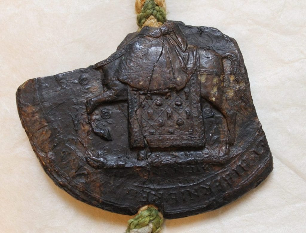 The bottom half of the Queen upon a horse, riding side saddle, on the seal of Mary I, attached to SGC X.3.7.