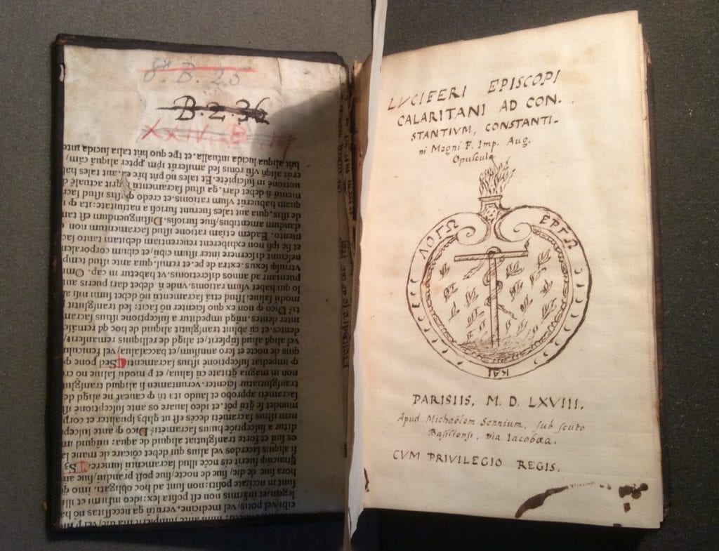 Photograph oPhotograph of a hand drawn title page, a highly accurate facsimile of the original print title page. Also visible are two manuscript fragments used in the binding of the book.f a hand drawn title page. Also visible are two manuscript fragments used in the binding of the book.