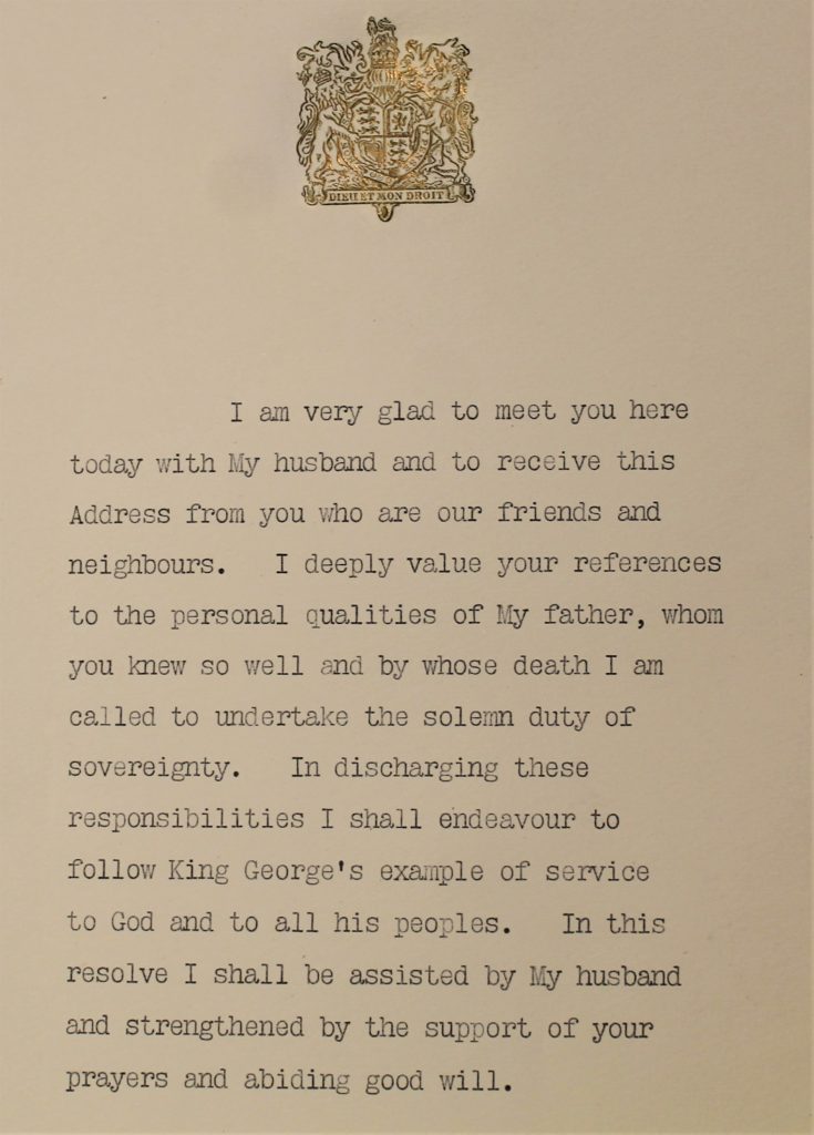 Typewritten black letters on white thick paper, with a gold embossed coat of arms at the top.